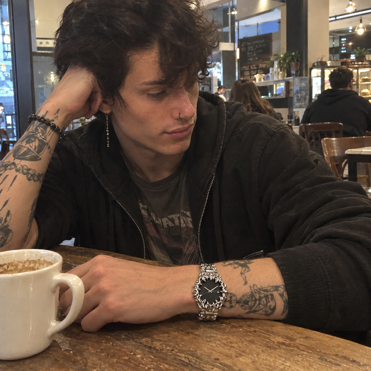 Man wearing a gothic silver watch